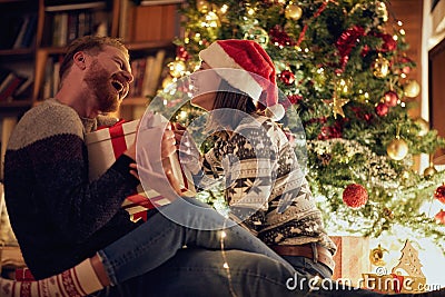 Smiling Christmas couple enjoying in the holidays Stock Photo