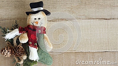 Cloth decorated snowman on a wood background Stock Photo