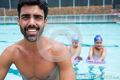 Smiling coach sitting near poolside Stock Photo