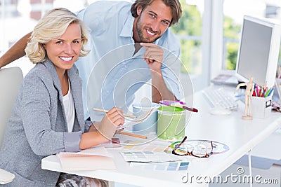Smiling colleagues of interior design working together Stock Photo