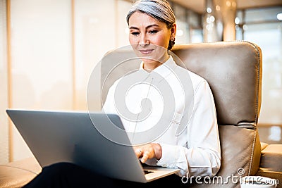 Smiling company boss with laptop stock photo Stock Photo