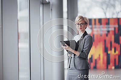 Smiling confident business woman looking at camera at office Stock Photo