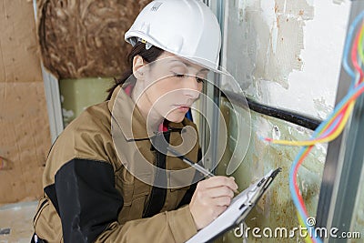 Smiling construction female worker holding clipboard Stock Photo