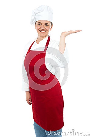 Smiling cook presenting copy space, open palm Stock Photo