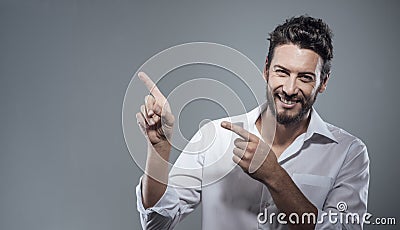 Smiling cool man pointing up Stock Photo