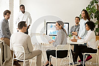 Smiling corporate employees talking about work results at team m Stock Photo