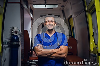 Smiling corpsman in medical uniform stands in the ambulance car Stock Photo