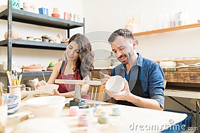Smiling Couple Doing Creative Painting On Bowls In Pottery Works Stock Photo