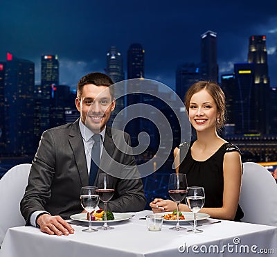 Smiling couple eating main course at restaurant Stock Photo