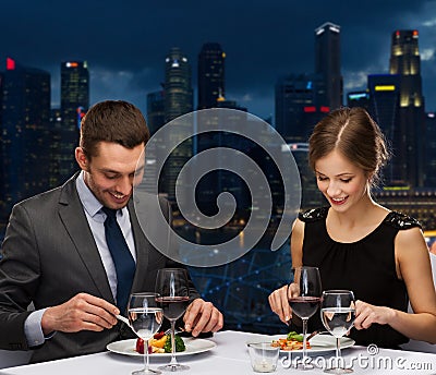 Smiling couple eating main course at restaurant Stock Photo