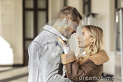 A smiling couple is in love outdoors.A young happy couple embraces on a city street Stock Photo