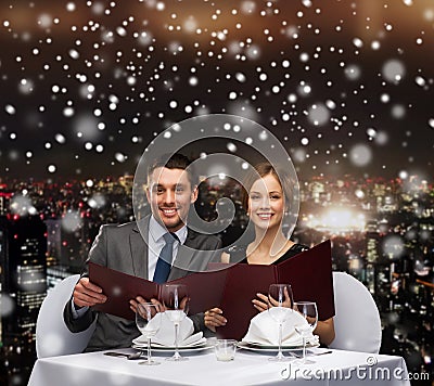 Smiling couple with menus at restaurant Stock Photo