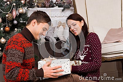 Smiling Couple with Presents Near Christmas Tree Stock Photo