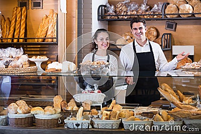 Smiling couple selling pastry and loaves Stock Photo