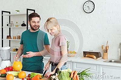 smiling couple of vegans preparing food Stock Photo
