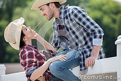 Smiling cowboy style couple flirting outdoors Stock Photo