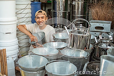 Smiling craftsman looking to the camera when installing the bucket handle Stock Photo