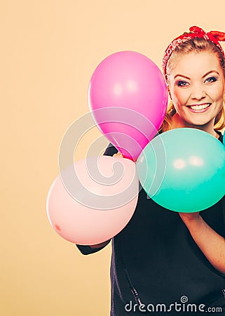 Smiling crazy girl having fun with balloons. Stock Photo