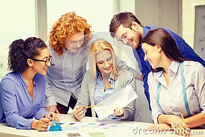 Smiling creative team looking at sketch Stock Photo