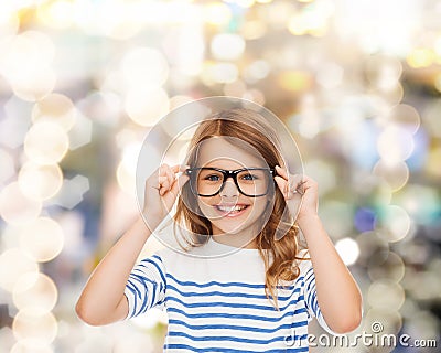 Smiling cute little girl with black eyeglasses Stock Photo