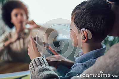 Deaf boy learning sign language. Selective focus Stock Photo