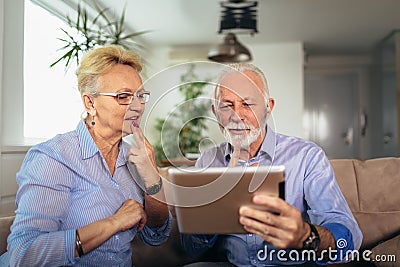 Smiling deaf senior couple talking using sign language on the digital tablet`s cam Stock Photo