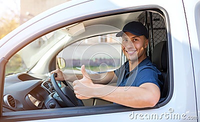 Delivery man sitting in a delivery van Stock Photo