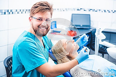 Dentist treating patient Stock Photo