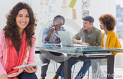 Smiling designer using tablet Stock Photo