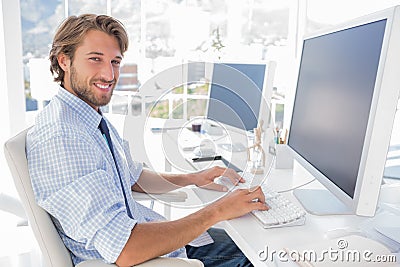 Smiling designer working at his desk Stock Photo