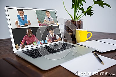 Smiling diverse elementary school pupils during class on laptop screen Stock Photo