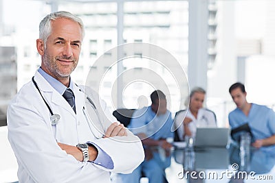 Smiling doctor with arms folded Stock Photo