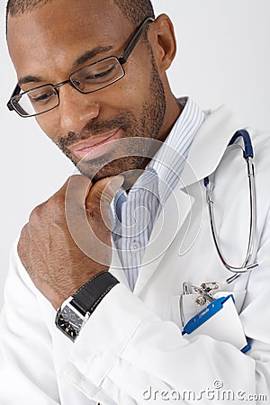 Smiling doctor thinking Stock Photo