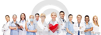 Smiling doctors and nurses with red heart Stock Photo