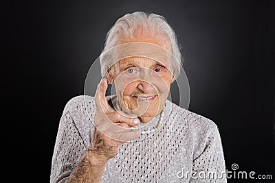 Smiling Elder Woman Waving Her Finger Stock Photo