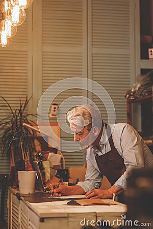 Smiling elderly man in uniform at work Stock Photo