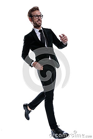 Smiling elegant man in black suit marching Stock Photo