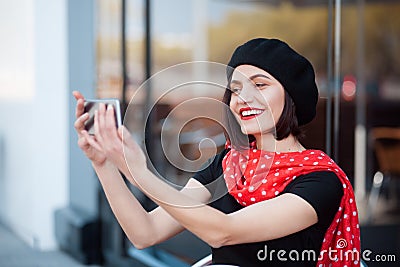 Smiling elegant woman taking selfie Stock Photo
