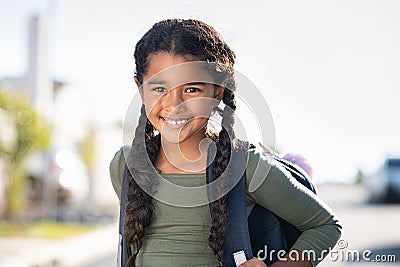 Smiling elementary school girl with bagpack Stock Photo