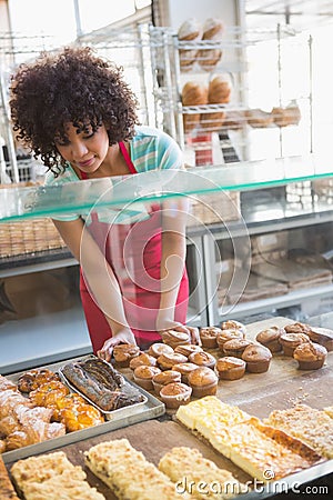 Smiling employee moving over the pastry Stock Photo