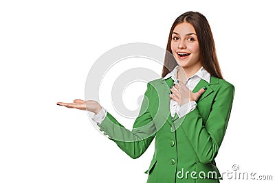 Smiling excited woman showing open hand palm with copy space for product or text. Business woman in green suit, isolated over whit Stock Photo