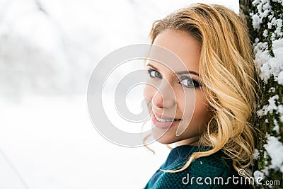 Smiling face of blond woman outside in winter nature Stock Photo