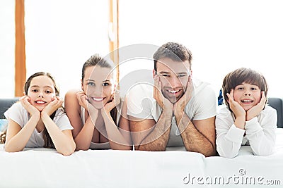 Smiling family in bed Stock Photo