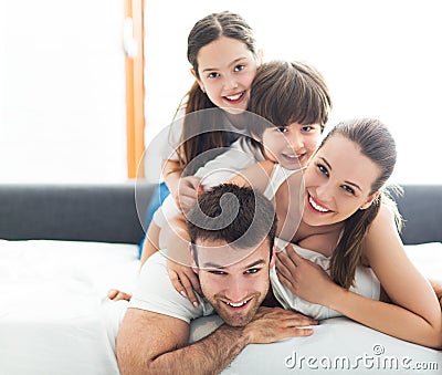 Smiling family in bed Stock Photo