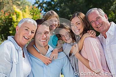 Smiling family and grandparents in the countryside embracing Stock Photo