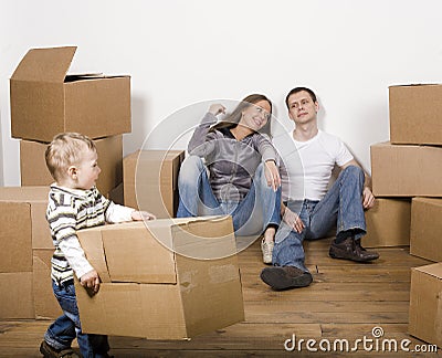 Smiling family in new house playing with boxes Stock Photo