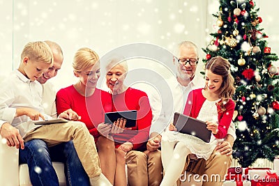 Smiling family with tablet pc computers at home Stock Photo