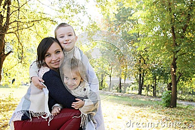 Smiling family together in plaid on autumn picnic Stock Photo