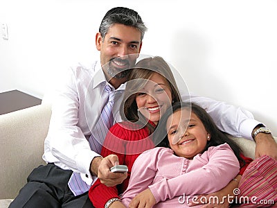 Smiling family watching TV in the living room Stock Photo