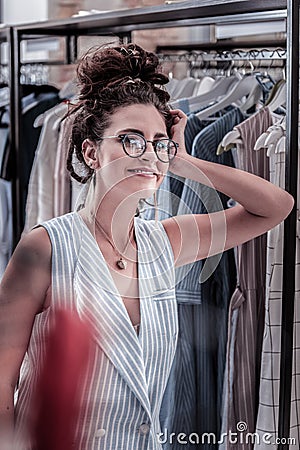 Smiling fashion designer with nice hair bun feeling inspired for new collection Stock Photo